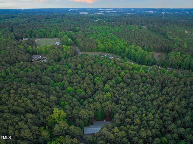 aerial view of property and surrounding area featuring a forest