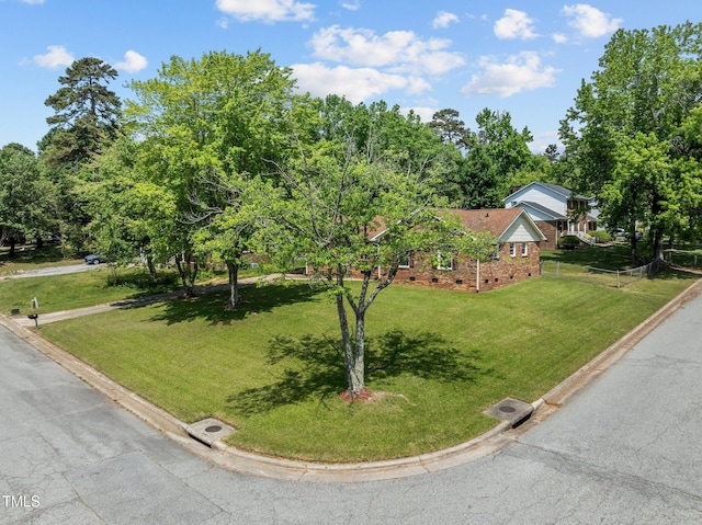 view of front of home with brick siding, a front lawn, and crawl space