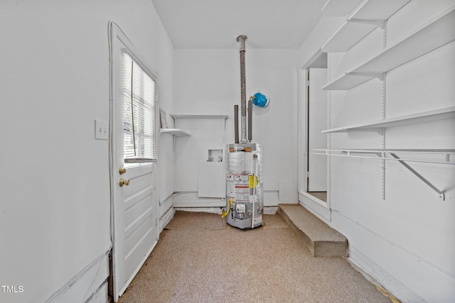 utility room featuring water heater