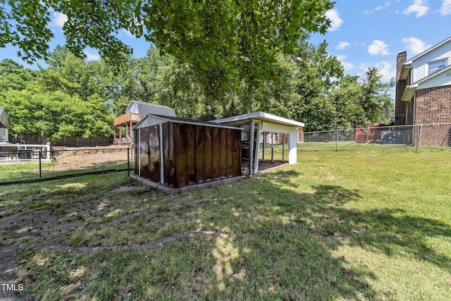 view of yard featuring a fenced backyard, a storage unit, and an outdoor structure
