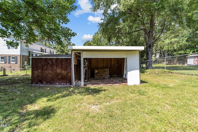view of outbuilding with fence and an outbuilding