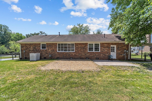 back of house featuring fence, a lawn, a patio area, and crawl space