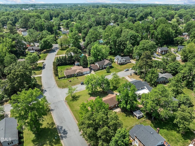 birds eye view of property with a view of trees and a residential view