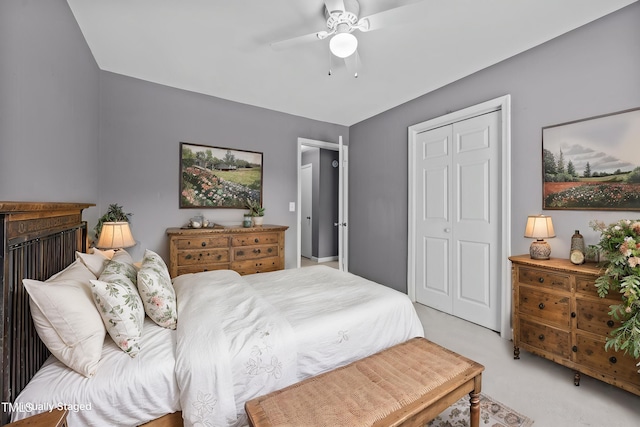 bedroom featuring a ceiling fan, light colored carpet, and a closet