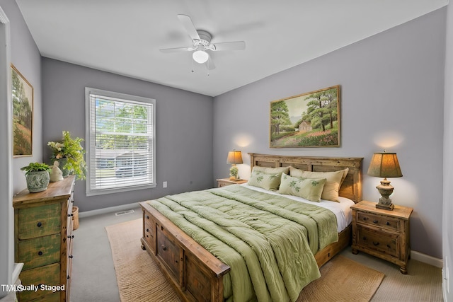 bedroom featuring baseboards, light colored carpet, ceiling fan, and visible vents