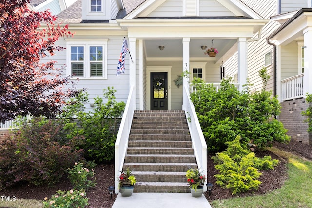 view of exterior entry with a porch