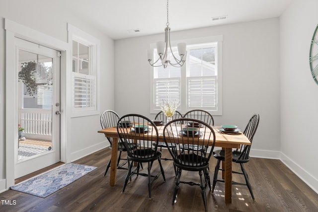dining room featuring baseboards, an inviting chandelier, visible vents, and dark wood-type flooring