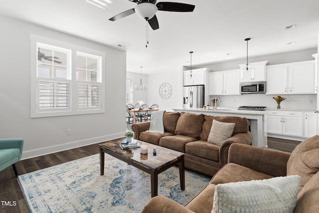 living area featuring visible vents, dark wood finished floors, baseboards, ceiling fan with notable chandelier, and recessed lighting