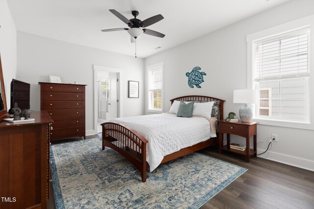 bedroom with baseboards, ceiling fan, dark wood-style flooring, and visible vents