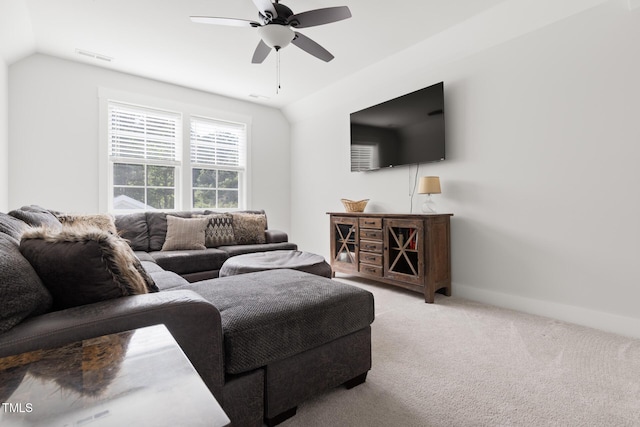 living area with light colored carpet, a ceiling fan, lofted ceiling, and visible vents