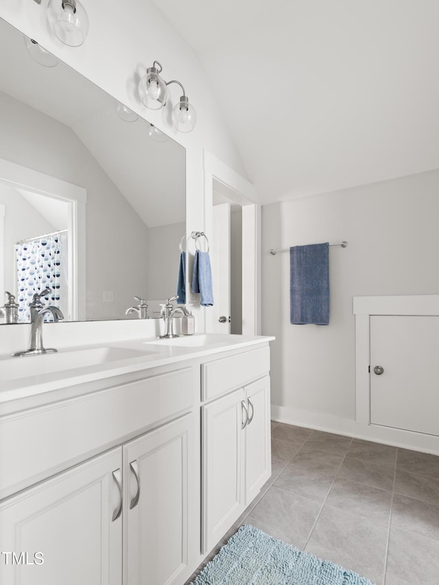 full bath with vanity, vaulted ceiling, and tile patterned floors