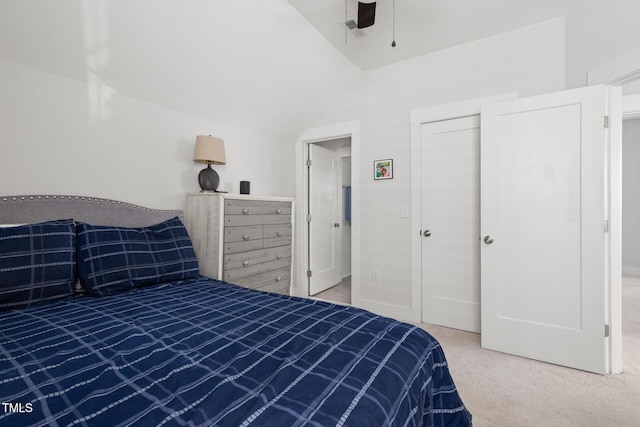 carpeted bedroom featuring a closet, ceiling fan, and vaulted ceiling