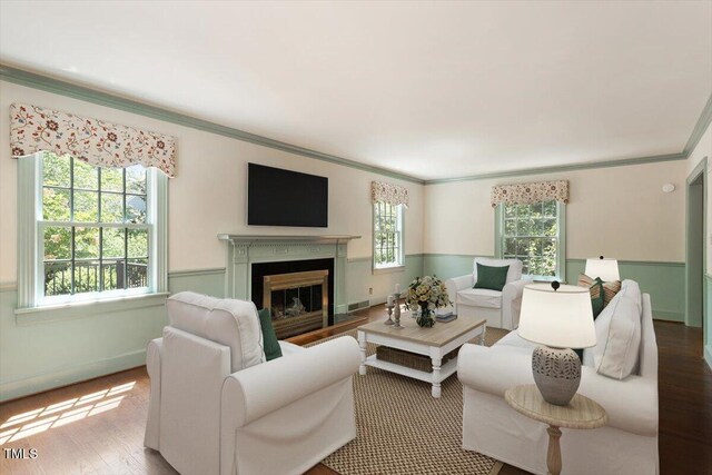 400 Bowling Creek Rd, Chapel Hill, NC 27514 - living room featuring a glass covered fireplace, baseboards, wood finished floors, visible vents, and ornamental molding
