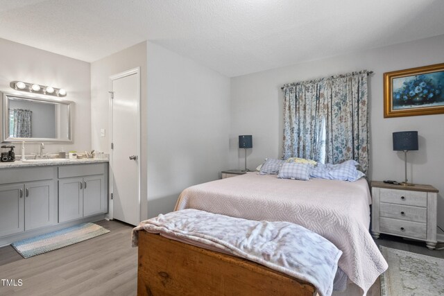 404 Creech St, Goldsboro, NC 27530 - bedroom with ensuite bathroom, a sink, and light wood finished floors