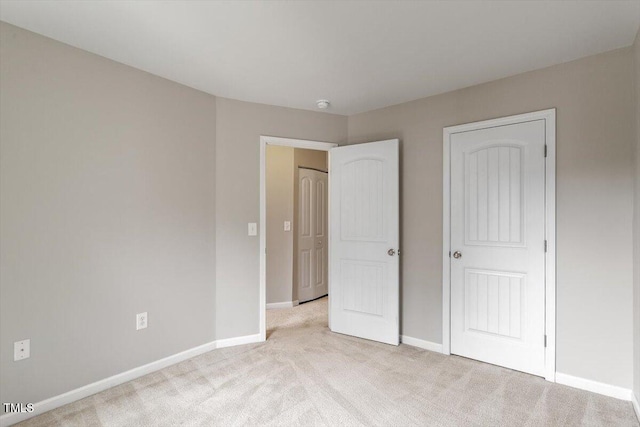 107 Tuftin Dr, Durham, NC 27703 - unfurnished bedroom with light colored carpet and baseboards