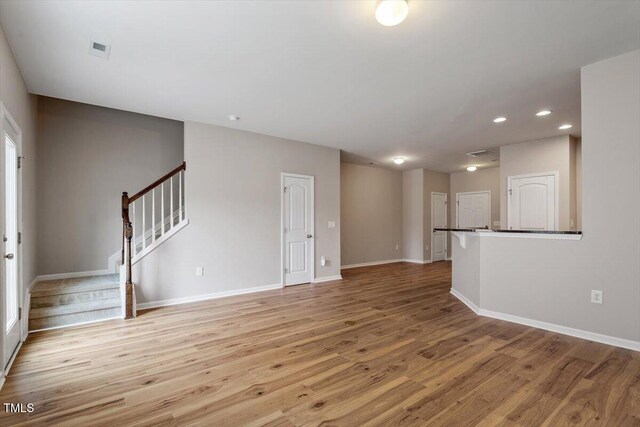 107 Tuftin Dr, Durham, NC 27703 - unfurnished room featuring stairway, light wood-type flooring, and recessed lighting