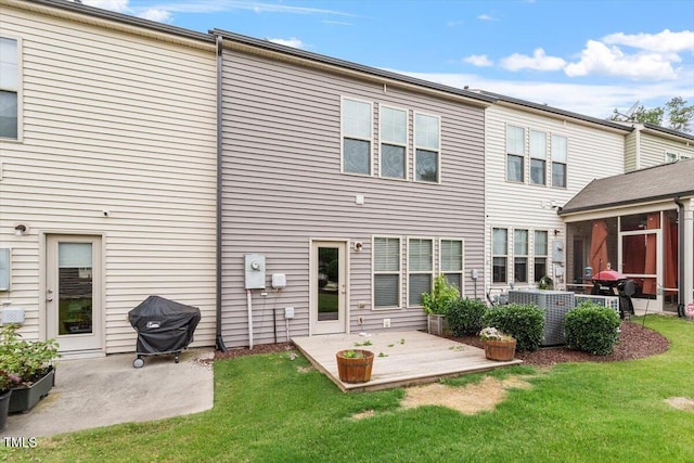 107 Tuftin Dr, Durham, NC 27703 - back of house featuring a patio, a lawn, and a sunroom