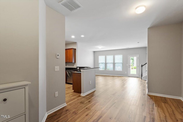 107 Tuftin Dr, Durham, NC 27703 - kitchen with open floor plan, light wood finished floors, brown cabinetry, recessed lighting, and stainless steel dishwasher