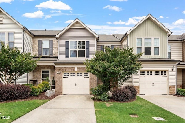 107 Tuftin Dr, Durham, NC 27703 - view of front of property featuring driveway, an attached garage, and stone siding