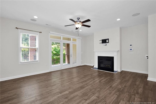 278 Hugh Shelton Loop, Fayetteville, NC 28301 - unfurnished living room featuring ceiling fan, a glass covered fireplace, recessed lighting, baseboards, and dark wood-type flooring