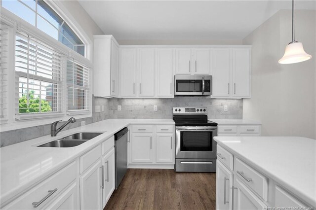 278 Hugh Shelton Loop, Fayetteville, NC 28301 - kitchen with dark wood-style flooring, light countertops, white cabinetry, a sink, and stainless steel appliances