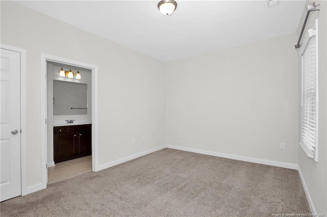 278 Hugh Shelton Loop, Fayetteville, NC 28301 - unfurnished bedroom with carpet flooring, baseboards, a sink, and ensuite bathroom