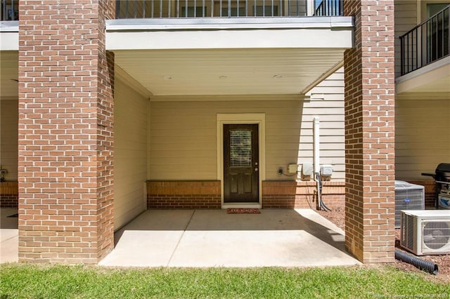 278 Hugh Shelton Loop, Fayetteville, NC 28301 - doorway to property with brick siding, a balcony, and a patio