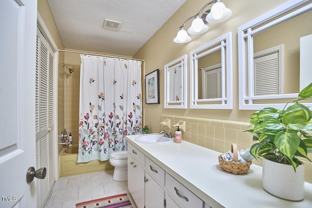 bathroom with visible vents, tile patterned flooring, vanity, shower / bath combination with curtain, and toilet