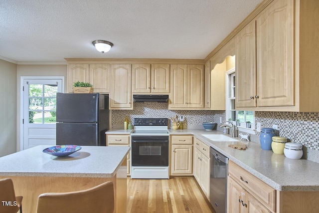 kitchen with a sink, dishwasher, light brown cabinets, electric range oven, and freestanding refrigerator
