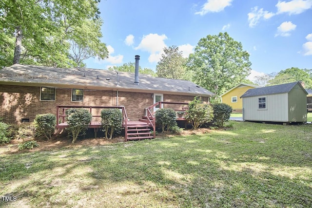 rear view of property with a deck, a storage unit, brick siding, a lawn, and an outbuilding