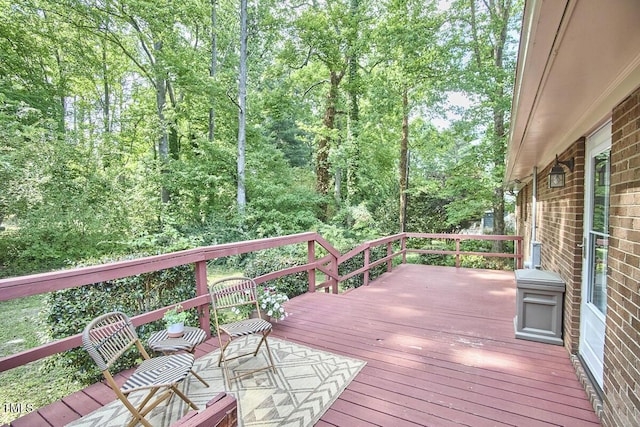wooden deck featuring a forest view