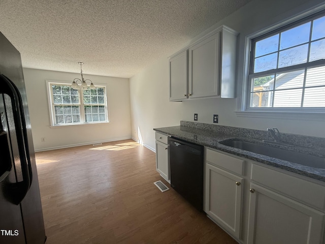 118 Hawthorn Dr, Clayton, NC 27520 - kitchen with a sink, a textured ceiling, dishwasher, dark wood-style flooring, and a notable chandelier