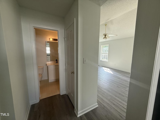 118 Hawthorn Dr, Clayton, NC 27520 - corridor with a textured ceiling, baseboards, and dark wood-style floors