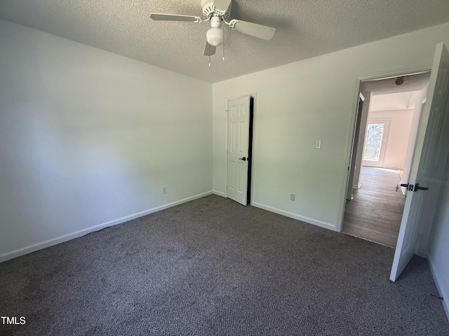 118 Hawthorn Dr, Clayton, NC 27520 - unfurnished bedroom with baseboards, dark colored carpet, and a textured ceiling