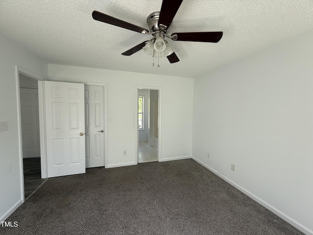 118 Hawthorn Dr, Clayton, NC 27520 - unfurnished bedroom featuring ceiling fan, a textured ceiling, baseboards, and dark carpet