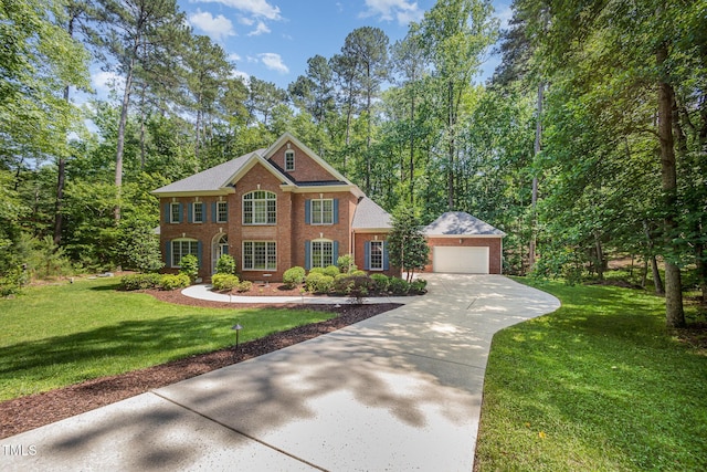 8840 Woodyhill Rd, Raleigh, NC 27613 - georgian-style home featuring brick siding, driveway, and a front yard