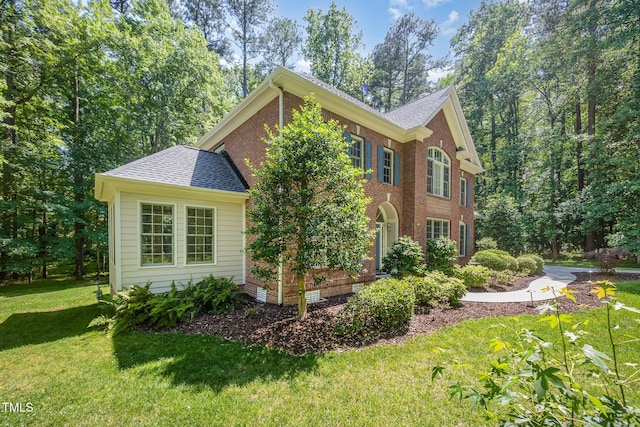 8840 Woodyhill Rd, Raleigh, NC 27613 - view of property exterior with a lawn, a shingled roof, and brick siding