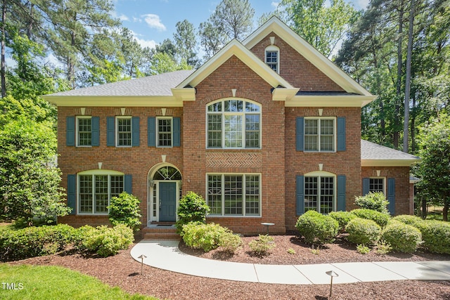 8840 Woodyhill Rd, Raleigh, NC 27613 - colonial house with brick siding and roof with shingles