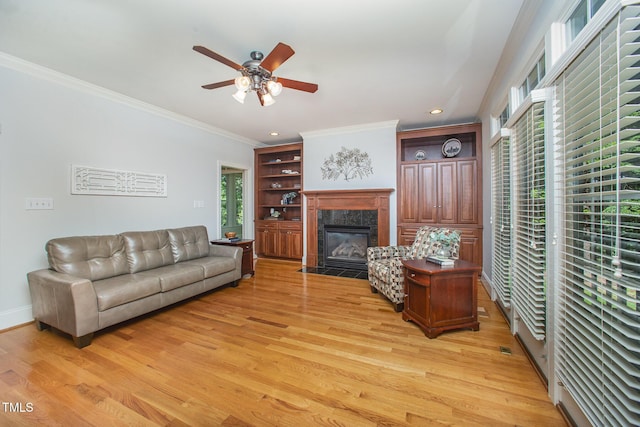 8840 Woodyhill Rd, Raleigh, NC 27613 - living area featuring a ceiling fan, a premium fireplace, light wood finished floors, plenty of natural light, and crown molding
