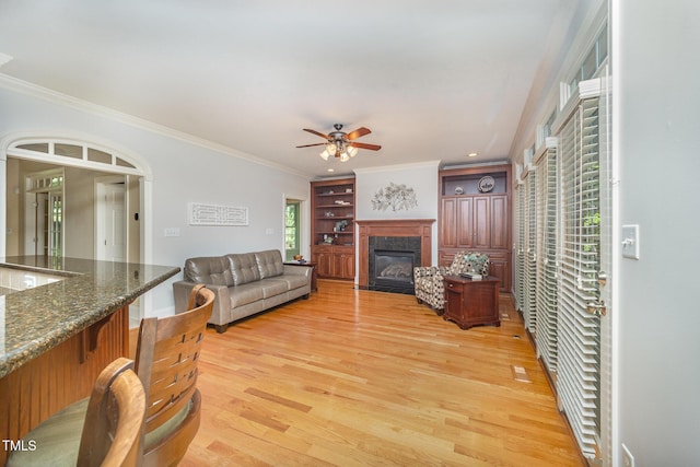 8840 Woodyhill Rd, Raleigh, NC 27613 - living room featuring ceiling fan, light wood-style floors, a fireplace with flush hearth, ornamental molding, and recessed lighting