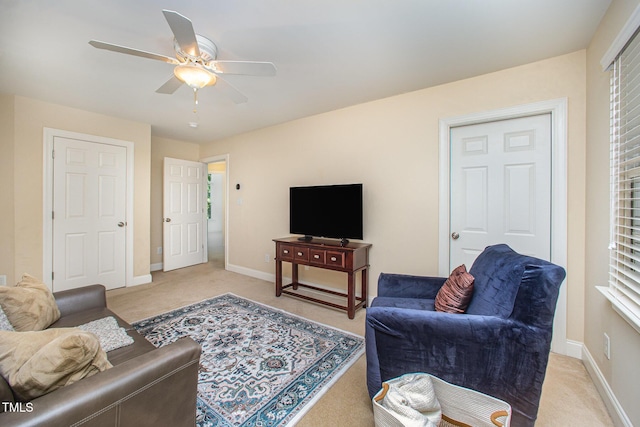 8840 Woodyhill Rd, Raleigh, NC 27613 - living area with light colored carpet, ceiling fan, and baseboards