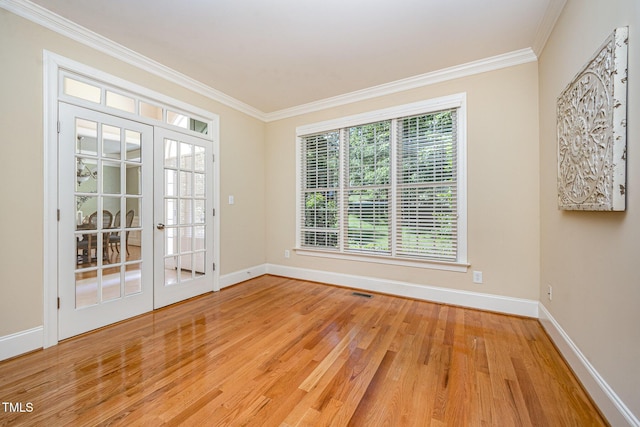 8840 Woodyhill Rd, Raleigh, NC 27613 - spare room with ornamental molding, baseboards, wood finished floors, and french doors