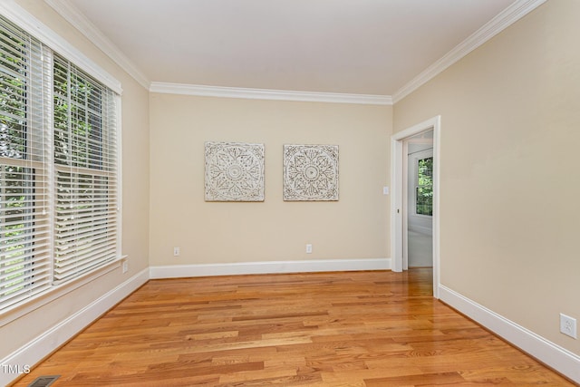 8840 Woodyhill Rd, Raleigh, NC 27613 - empty room with crown molding, light wood-style floors, and baseboards