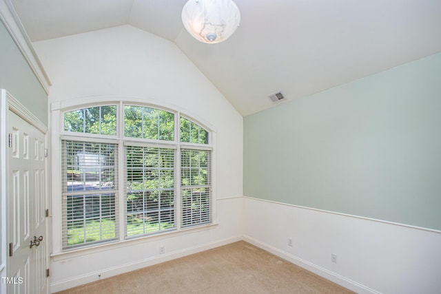 8840 Woodyhill Rd, Raleigh, NC 27613 - spare room with vaulted ceiling, light colored carpet, and baseboards