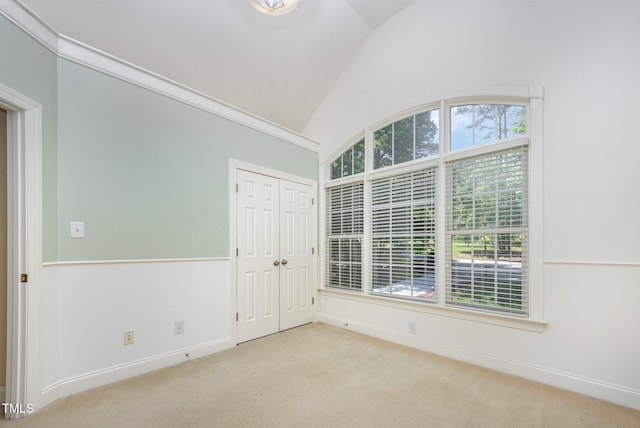 8840 Woodyhill Rd, Raleigh, NC 27613 - empty room featuring lofted ceiling, carpet flooring, and baseboards