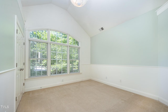 8840 Woodyhill Rd, Raleigh, NC 27613 - unfurnished room with vaulted ceiling, light carpet, and baseboards