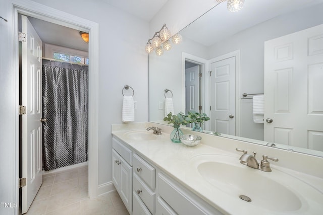 8840 Woodyhill Rd, Raleigh, NC 27613 - full bathroom with double vanity, tile patterned flooring, baseboards, and a shower with shower curtain