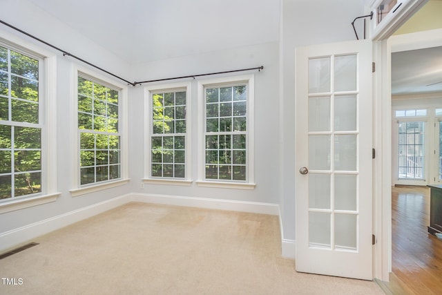 8840 Woodyhill Rd, Raleigh, NC 27613 - unfurnished sunroom featuring baseboards and carpet floors