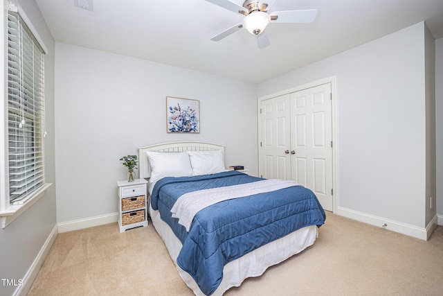 8840 Woodyhill Rd, Raleigh, NC 27613 - bedroom featuring light carpet, baseboards, a closet, and a ceiling fan