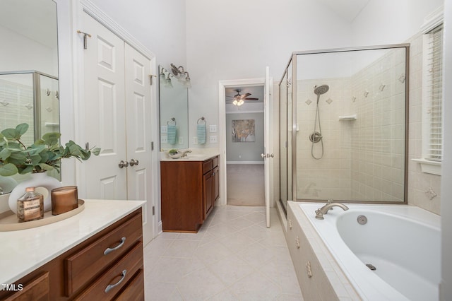 8840 Woodyhill Rd, Raleigh, NC 27613 - full bathroom with tile patterned flooring, a ceiling fan, a garden tub, a stall shower, and vanity
